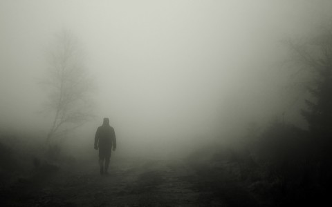 man walking in fog